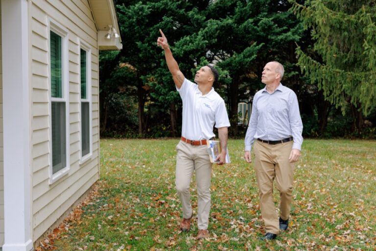 Roofing professional discussing repair costs with a Delaware homeowner