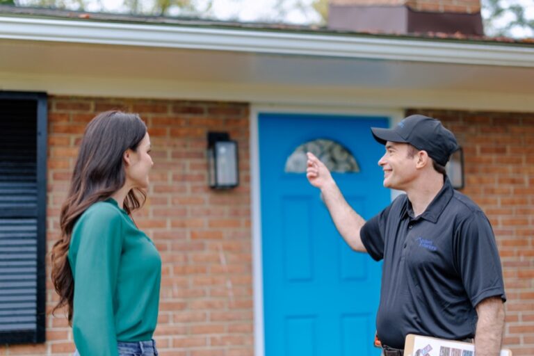 Modern Exteriors technician consulting with homeowner about insulation