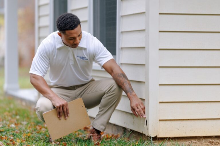 Inspector examining roof structure with clipboard for detailed assessment