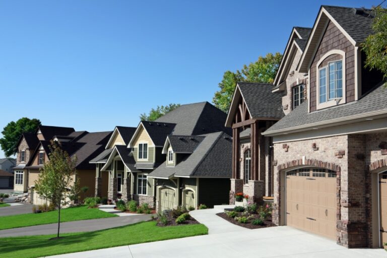 Two-story house with brick facade multi-gabled roof and covered front porch