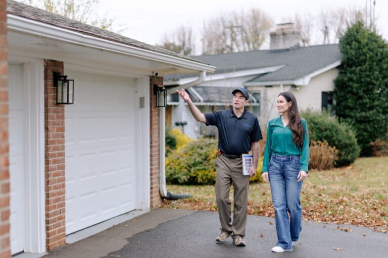 Team member walking exterior with homeowner reviewing completed work