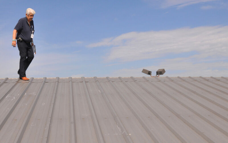 Roofing inspector walking a roof during a roof inspection