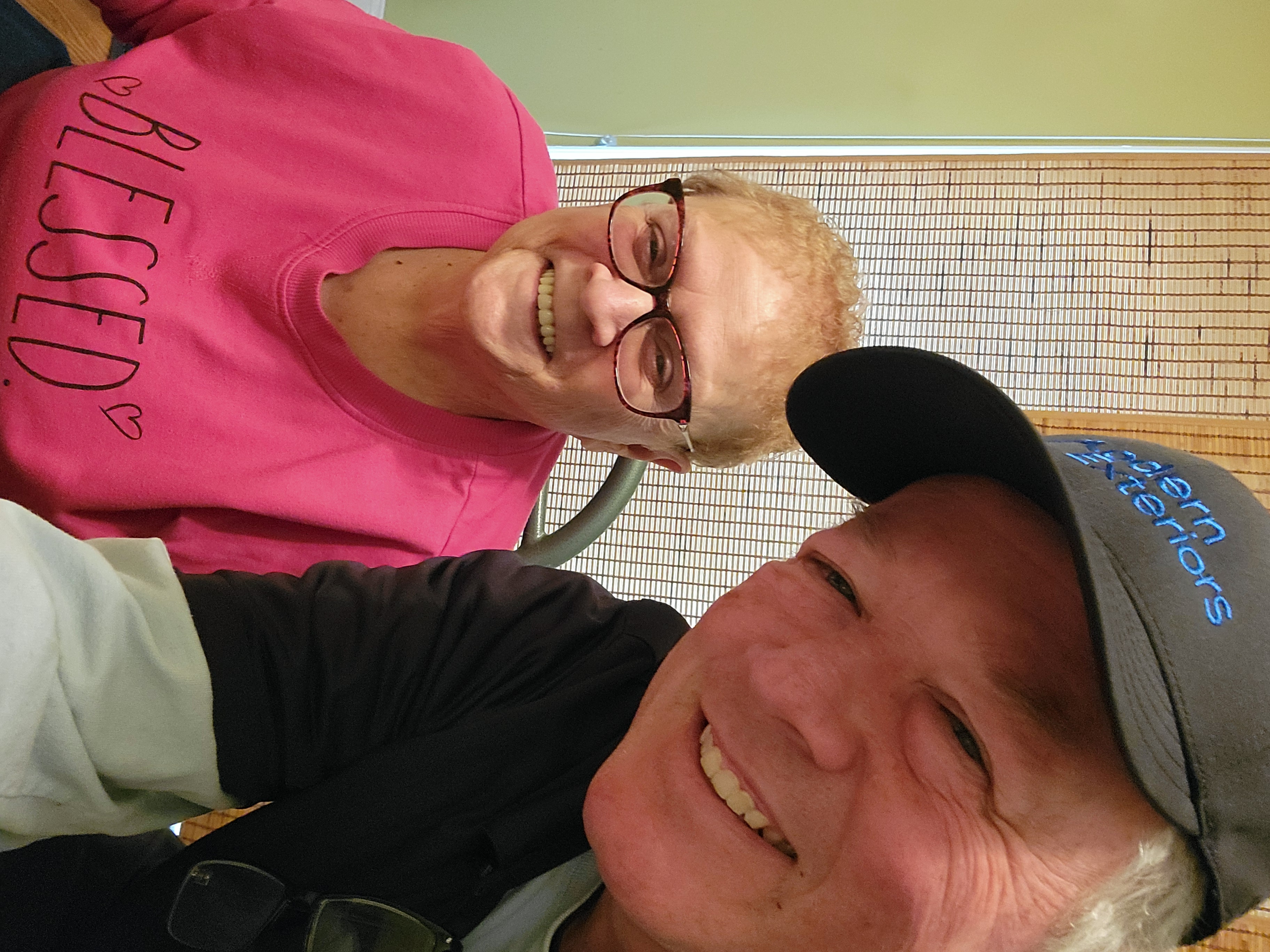 Smiling homeowner with Modern Exteriors team member