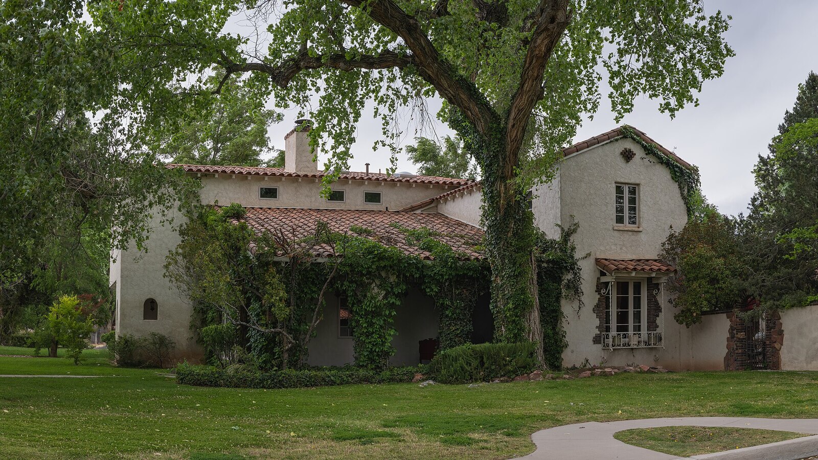 Stucco exterior wall with a tile roof on a Mediterranean-style home