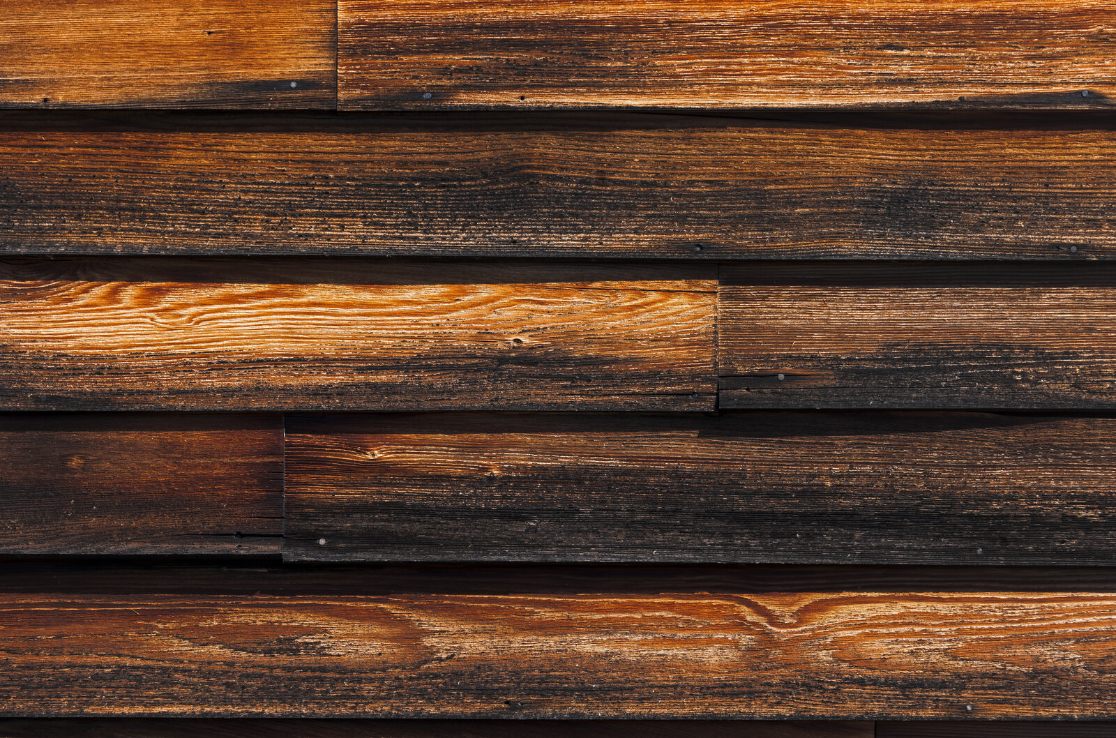 Close-up of stained wood clapboard siding showing natural grain